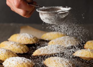 Tangerine Madeleines Tangerine Madeleines on wire rack with confectioners sugar