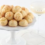 Gougères with champagne on white