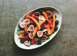 Tropical Fall Salad Tropical Fall Salad in a white bowl on darker surface