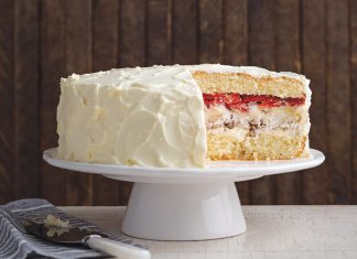 Pecan Meringue Cake Pecan Meringue Cake on white cake stand sliced