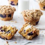 Peach and Blueberry Cornmeal Muffins split with butter