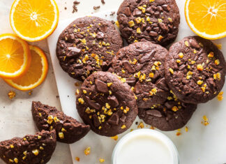 Orange-Chocolate Brownie Cookies Orange-Chocolate Brownie Cookies stacked on white marble overhead with orange slices