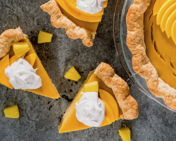 Roasted Mango and Pineapple Pie sliced on gray surface