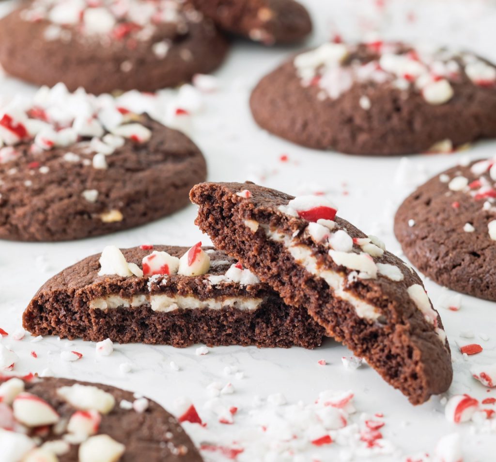 Peppermint Custard-Stuffed Chocolate Cookies split in half on white