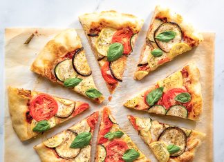 Ratatouille Pizza ratatouille pizza sliced on parchment paper