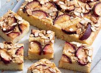 Vanilla Plum Sheet Cake Vanilla Plum Sheet Cake sliced on parchment