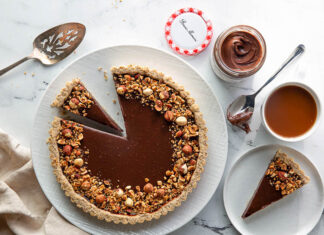 Hazelnut-Chocolate Tart chocolate hazelnut tart overhead sliced on white plate