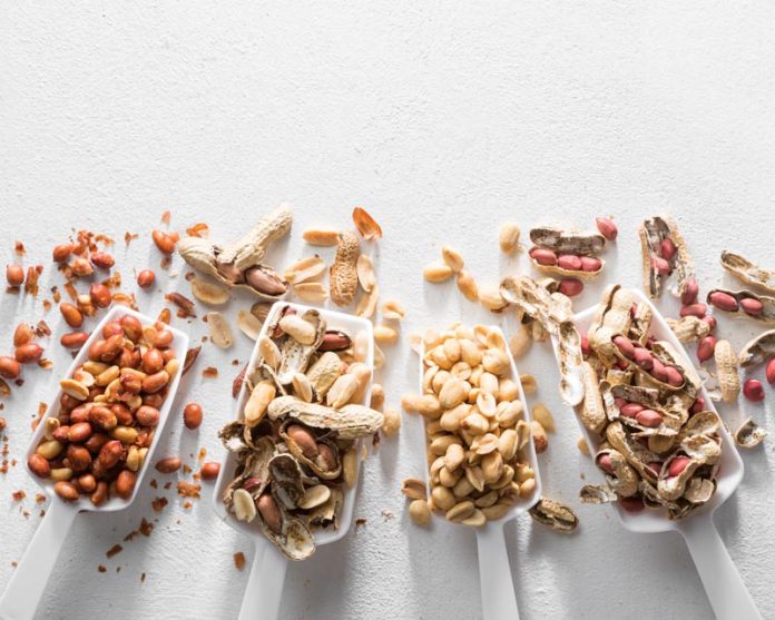 different peanuts in scoops on table
