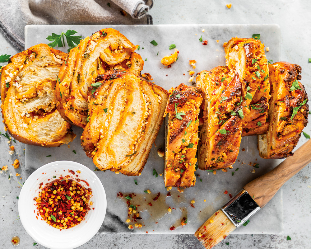 Goat Cheese-Harissa Babka sliced on marble