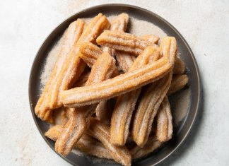 Baking School In-Depth: Churros Baking School In-Depth: Churros on gray plate filled with cinnamon sugar