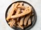 Baking School In-Depth: Churros Baking School In-Depth: Churros on gray plate filled with cinnamon sugar