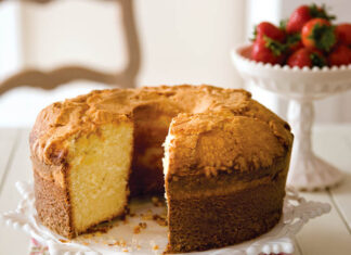 Jo’s Whipping Cream Pound Cake whipping cream pound cake on a plate with a bowl of strawberries