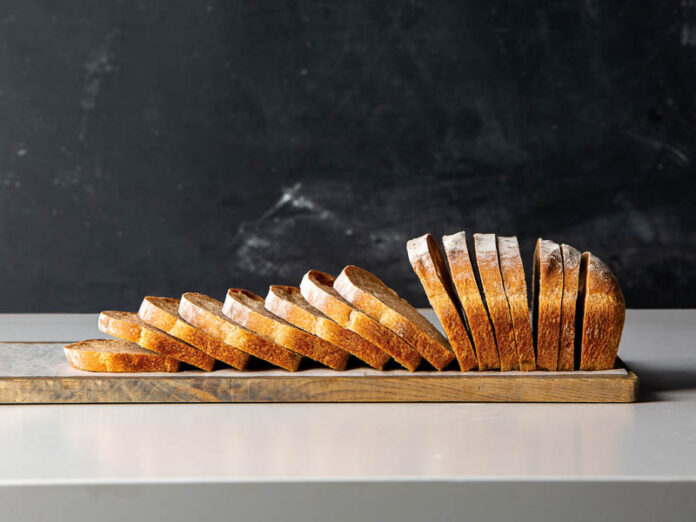 Sliced loaf of sourdough bread on a cutting board