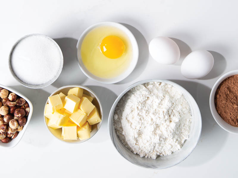 ingredients for cake on white marble surface