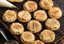 Chai Spice Cookies with Vanilla Frosting chai spice cookies with vanilla frosting topped with cinnamon on wire rack.