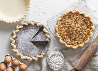 11 Perfect Pies and Tarts for Thanksgiving pies on white surface with ingredients surrounding