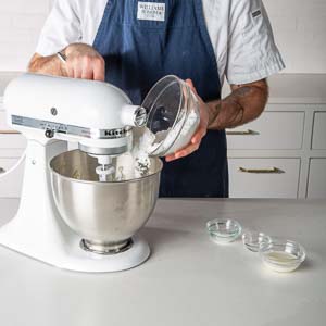 Adding confectioners' sugar to mixer