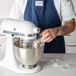 Adding cream to mixing bowl