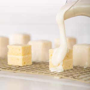 Pouring glaze over petit fours