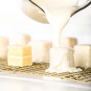 Pouring fondant over petit fours