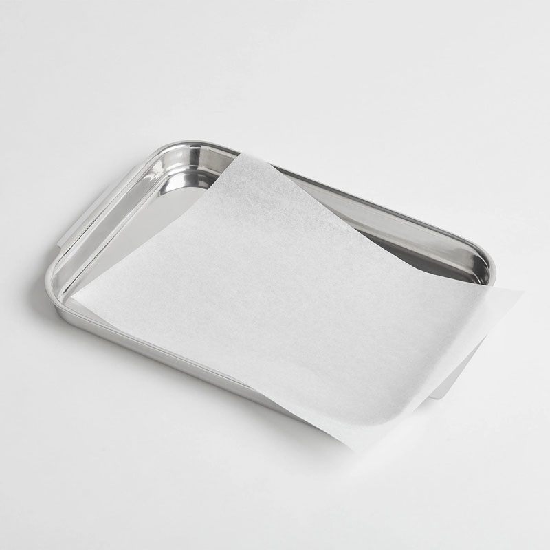 Parchment paper sheet on silver baking tray