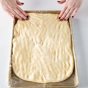Spreading dough on baking sheet