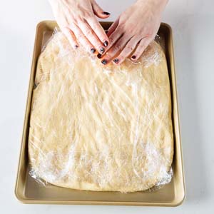 Spreading dough on baking sheet