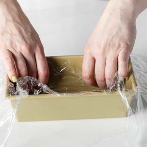 Prepping the pan with plastic wrap
