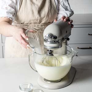 Adding ingredients to stand mixer