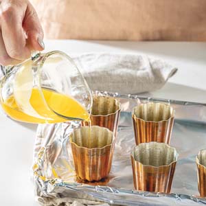 Pouring batter in canele mold