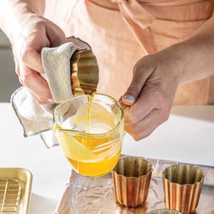 Pouring batter out of canele molds