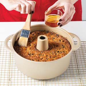 Brushing brandy onto cake