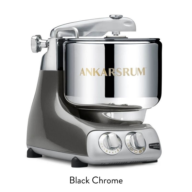 Silver chrome stand mixer on a gray base with control dials on the front, ready for baking.