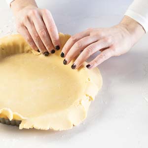 Putting dough in tart pan