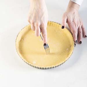 poking holes in tart dough with fork