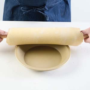 Putting dough in pie dish