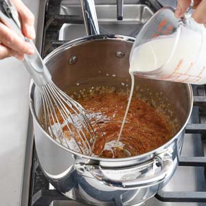 Adding cream to caramel
