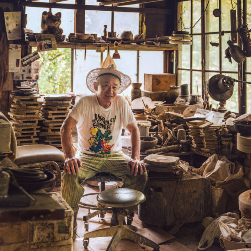 Man sitting on a chair wearing a hat