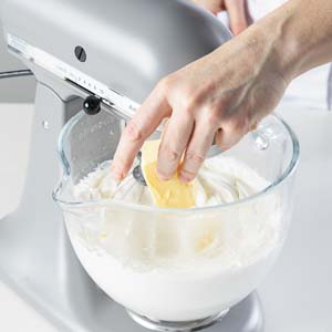 adding butter to buttercream