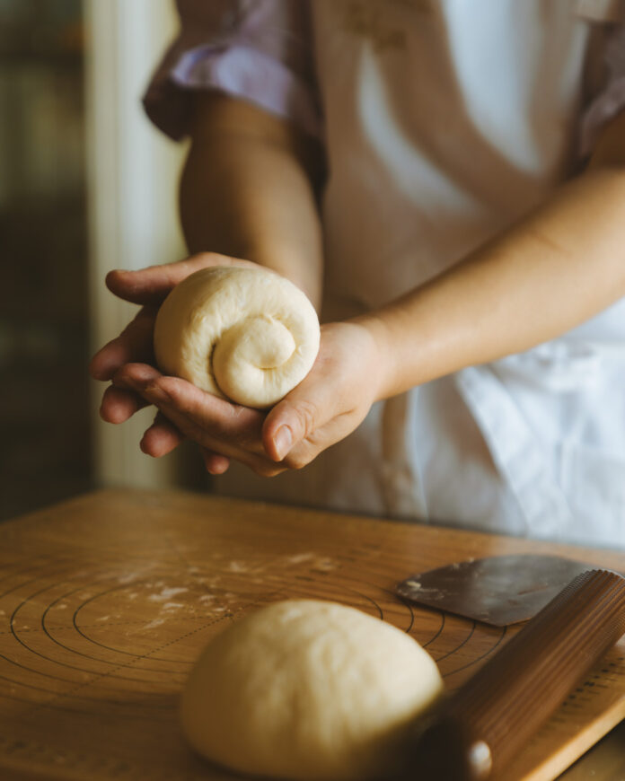 Shaping shokupan bread dough.