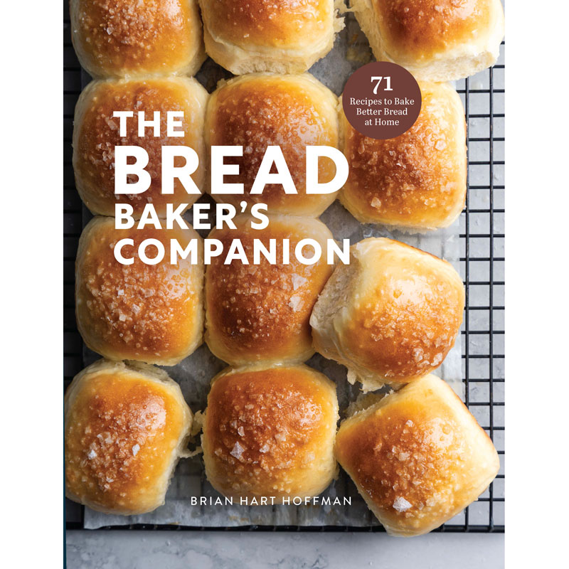 Cover of 'The Bread Baker's Companion' showing a tray of golden dinner rolls on a cooling rack with the author, Brian Hart Hoffman, at the bottom edge and a brown badge that says 71 recipes to bake better bread at home.