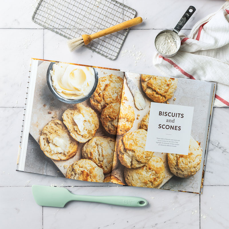 800x800Biscuits-and-Scones-Opener018KG - Bake from Scratch Bread Baker's Companion chapter opener with mint spatula, pastry brush, wire rack, and red/white stripe towel