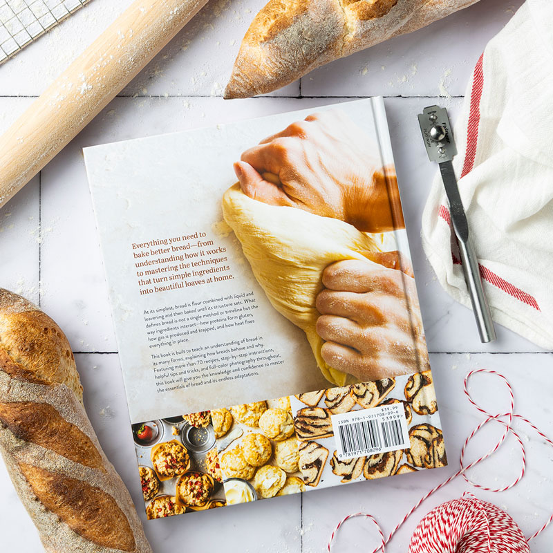 800x800Bread-Bakers-Companion-Back-Cover004KG - Bake from Scratch Bread Baker's Companion chapter opener with mint spatula, breadloaf, rolling pin, and red/white stripe towel