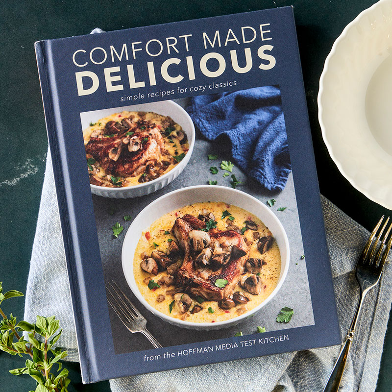 800x800Marketing-8_25JB160 - Bake from Scratch Comfort Made Delicious styled cover with plate, napkin, and herbs
