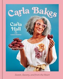 Book cover for Carla Bakes by Carla Hall with Lauren Chattan, showing Carla holding macarons and a heart-shaped treat on a teal background with pink border.