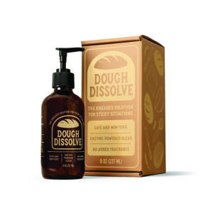 Dough Dissolve bottle beside its brown box with the label 'Dough Dissolve' and '8 oz (237 ml)' visible on the packaging, on a white background.