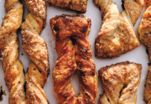 Cardamom Twists Close-up of golden-brown twisted pastries sprinkled with coarse sugar on a light background.