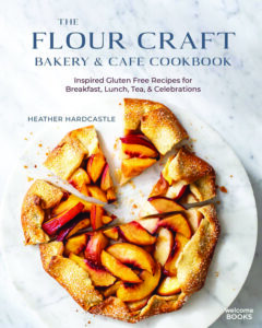 Cover of 'The Flour Craft Bakery & Cafe Cookbook' with a peach galette on a marble plate.